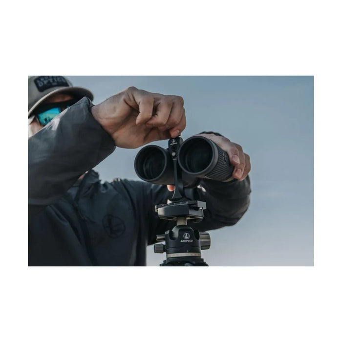 A Man Setting Up the Leupold Quick Stem Binocular Tripod Adapter to a Binocular