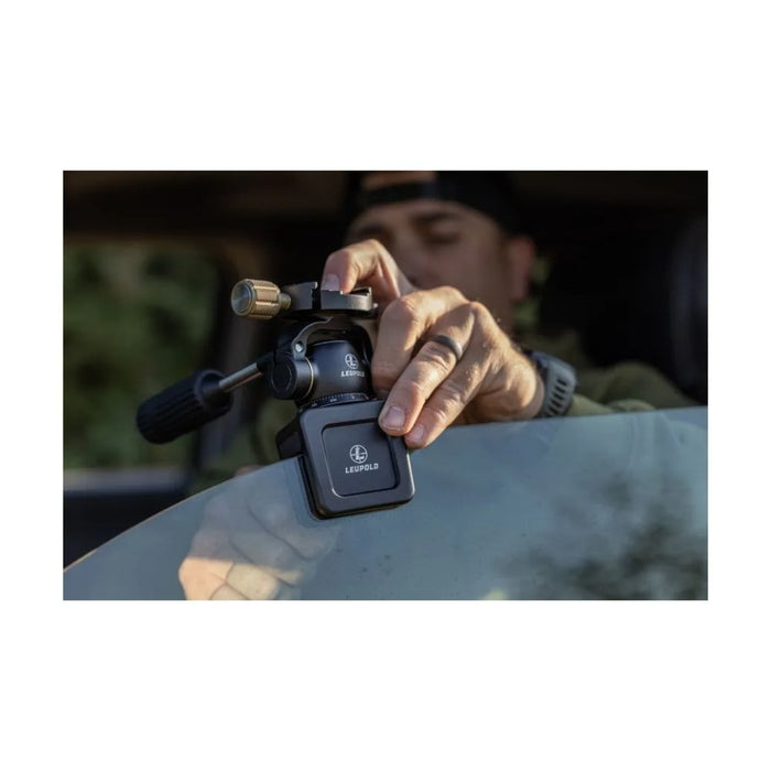 A Man Setting Up the Leupold Tripod Pan Head on Car Window