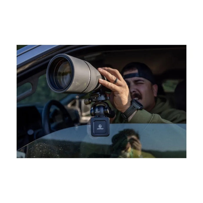 A Man Using a Telescope with the Leupold Tripod Pan Head on Car Window