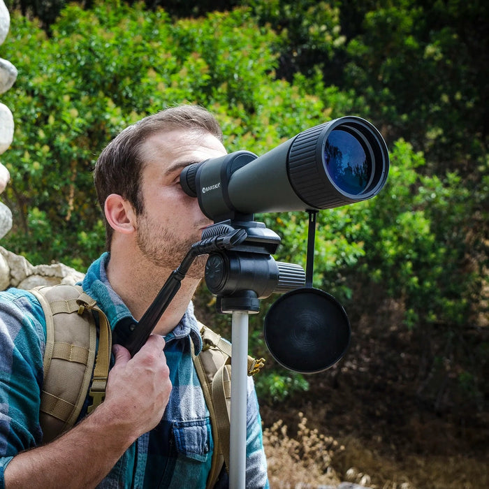 A Man Using the Barska 25-125x88mm WP Benchmark Spotting Scope Outdoors