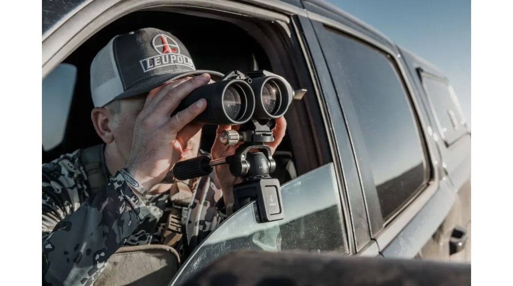 A Man Using the Leupold Optics Window Mount Clamped to Car Window with Binocular