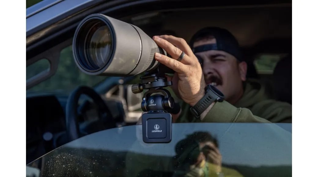 A Man Using the Leupold Optics Window Mount Clamped to Car Window with Spotting Scope