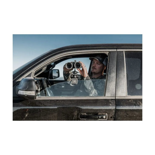 A Man Using the Leupold Quick Stem Binocular Tripod Adapter with Binocular Outdoors