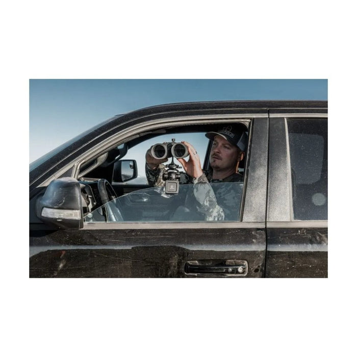 A Man Using the Leupold Quick Stem Binocular Tripod Adapter with Binocular Outdoors