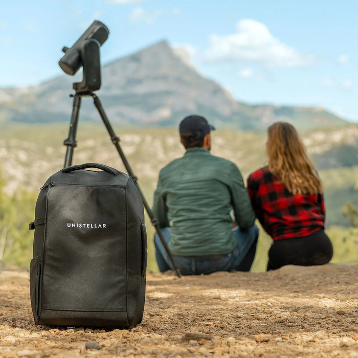 A Couple Sitting with Unistellar Backpack for Odyssey Pro and Odyssey Outdoors