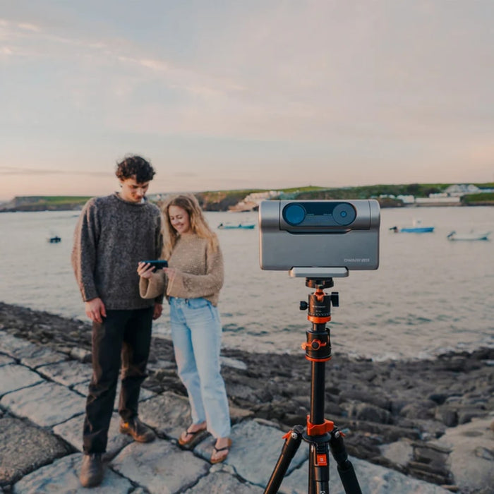 A Couple Using the DWARF 3 Smart Telescope on Tripod Beach Outdoors