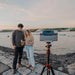 A Couple Using the DWARF 3 Smart Telescope on Tripod Beach Outdoors