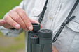 A Man Adjusting the Eyepiece of the Kowa BD III-XD 10x42mm Binocular - Lifestyle Photo Outdoor