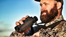 A Man Holding German Precision Optics Passion ED 8×42mm Binoculars Outdoors