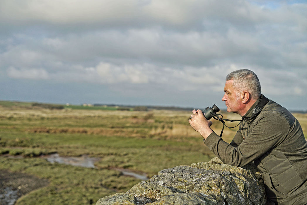 A Man Holding Kowa SV II 10x42mm Roof Prism Binocular Outdoors