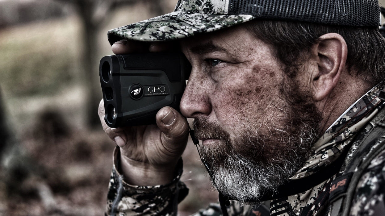 A Man Holding the German Precision Optics GPO Rangetracker 1800 6x20mm Handheld Rangefinder Lifestyle Photo Outdoors