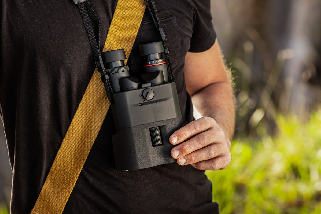 A Man Holding the Kite Optics 16x42mm ED APC Stabilized Binoculars - Lifestyle Photo Outdoors