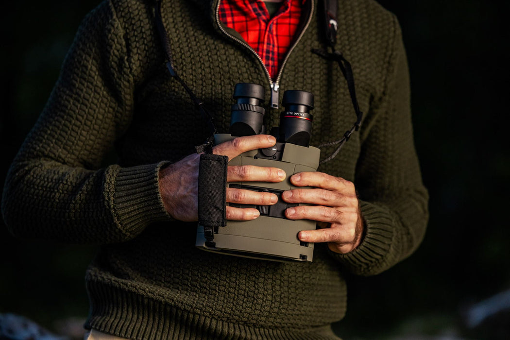 A Man Holding the Kite Optics 22x50mm ED APC Stabilized Binoculars - Lifestyle Photo Outdoors