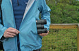 A Man Holding the Kowa BD III-XD 10x32mm Binocular Into His Jacket - Lifestyle Photo