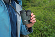 A Man Holding the Kowa BD III-XD 10x32mm Binocular with Neck Strap - Lifestyle Photo