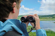 A Man Holding the Kowa BD III-XD 8x32mm Binocular - Lifestyle Photo Outdoor