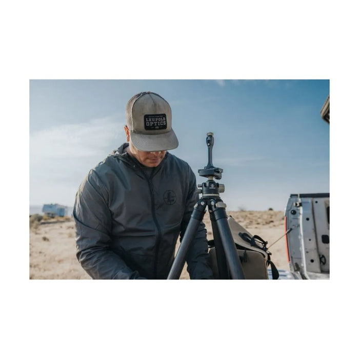 A Man Standing Beside the Leupold Quick Stem Binocular Tripod Adapter  Outdoors