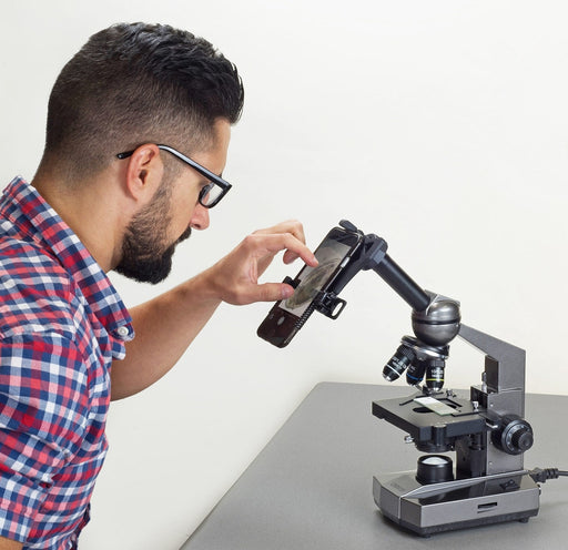 A Man Using Carson Intermediate 100x-1000x LED Compound Microscope and Smartphone Adapter