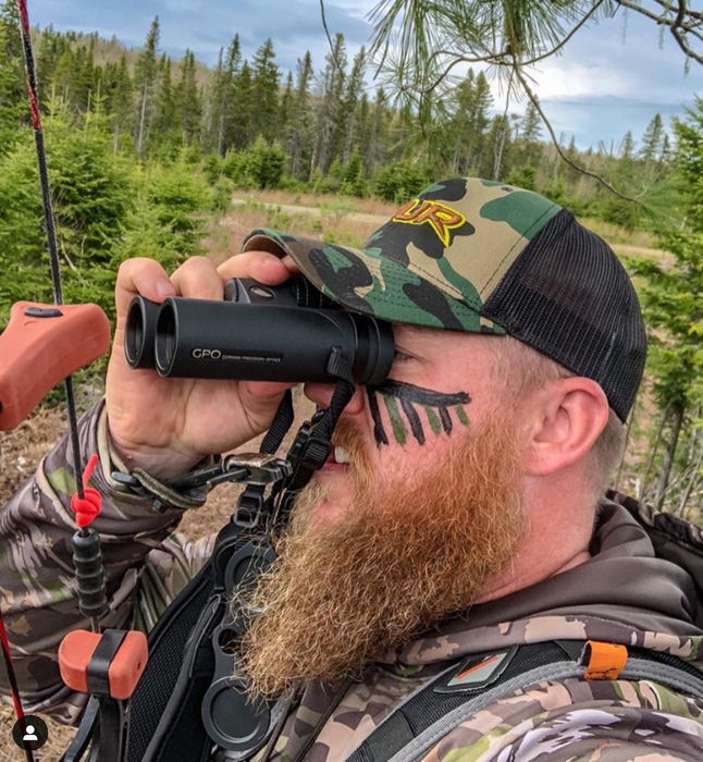 A Man Using German Precision Optics GPO Passion ED 8×32mm Binoculars Outdoors