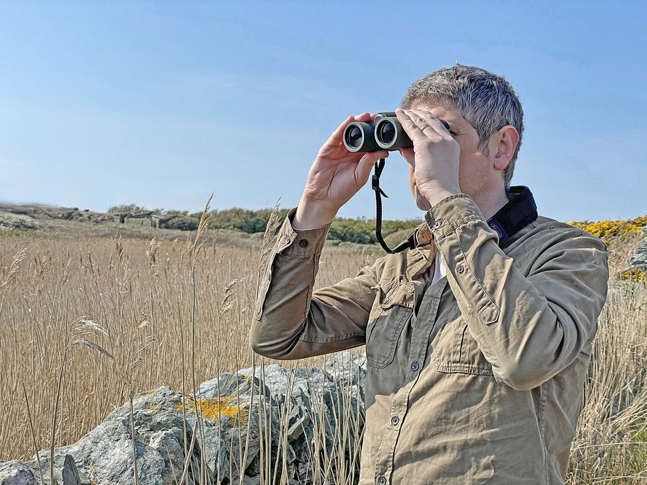 A Man Using Kowa BDII-XD 8x32mm Prominar Roof Prism Wide Angle Binocular