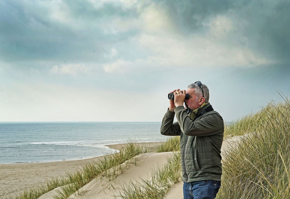A Man Using Kowa BDII-XD 8x42mm Prominar Roof Prism Wide Angle Binocular