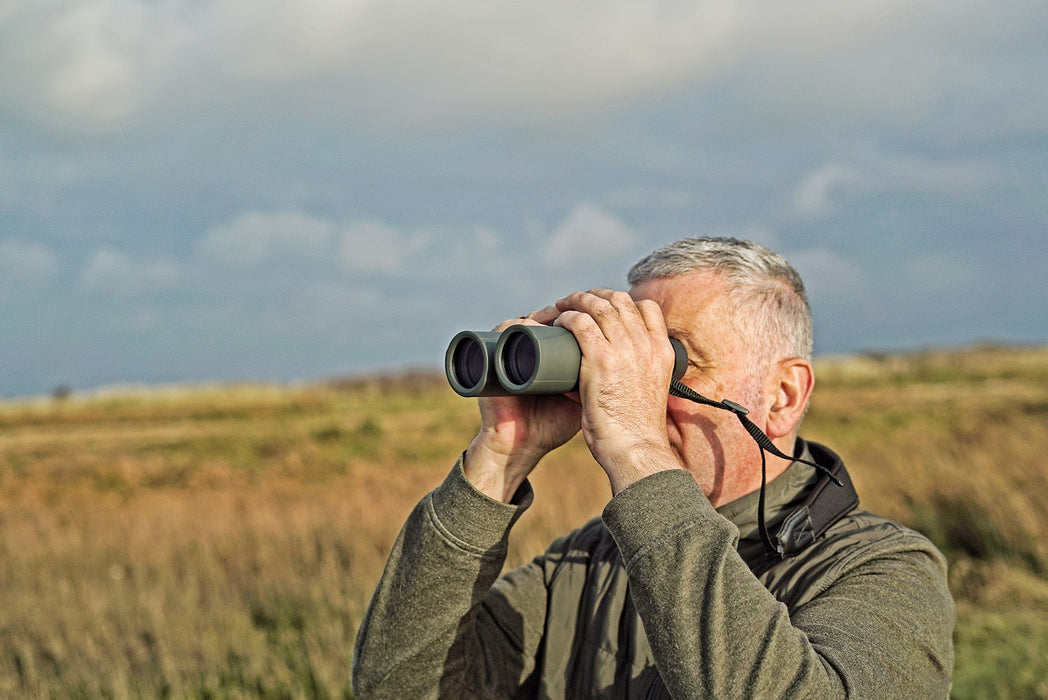 A Man Using Kowa SV II 8x32mm Roof Prism Binocular Outdoors