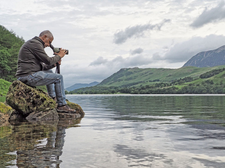 A Man Using Kowa TSN-553 15-45x55mm Angled Spotting Scope Outdoors