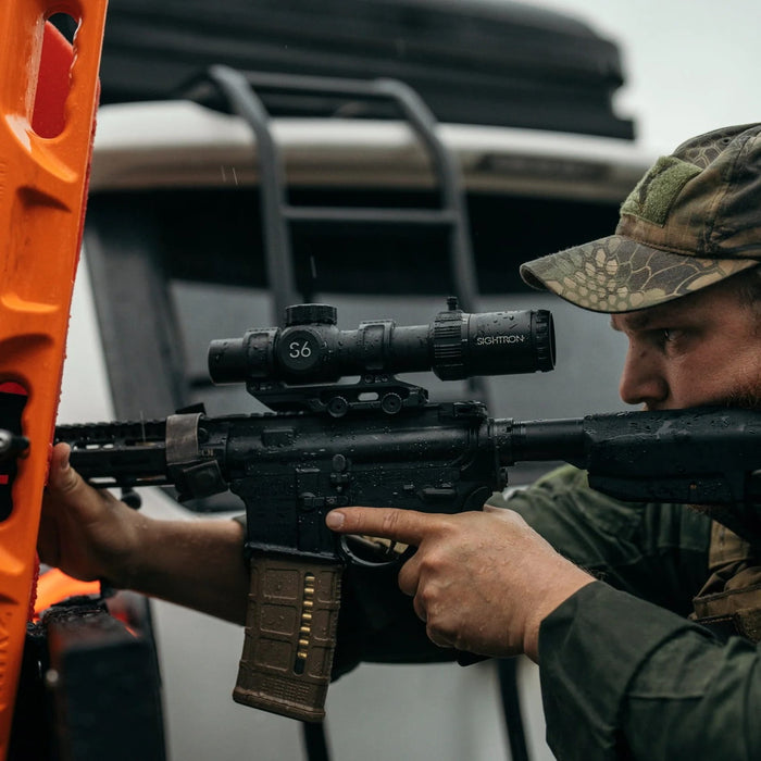 A Man Using a Rifle with Sightron S6 1-6x24mm FFP LRT Riflescope - Lifestyle Photo Outdoor