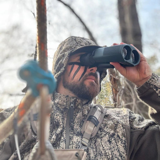 A Man Using the Alphen Apex Steady 14x42mm HD Binoculars with Image Stabilization Outdoors