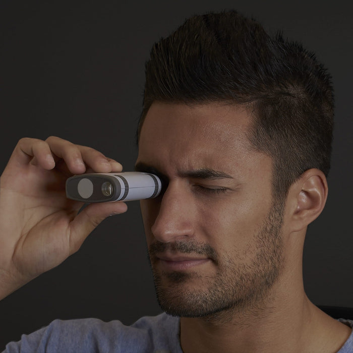 A Man Using the Carson MiniAura Digital Night Vision Monocular 