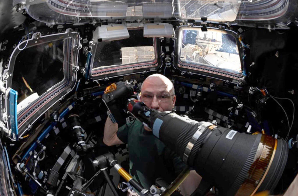 A Man Using the DayStar Camera Quark Adapter for Nikon SLR in Space