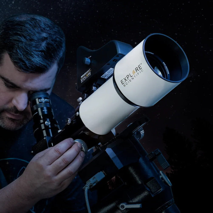 A Man Using the Explore Scientific ED80 Triplet Refractor with 0.8x Focal Reducer - Telescope Setup for Night Sky Observation