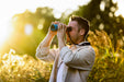 A Man Using the Kite Optics 10x30mm APC Stabilized II Binoculars - Lifestyle Photo Outdoor