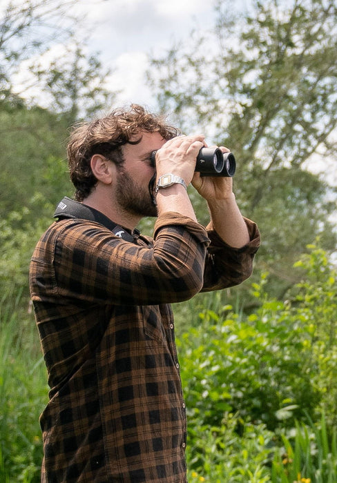 A Man Using the Kite Optics 10x30mm LYNX HD+ Binoculars- Lifestyle Photo Outdoors