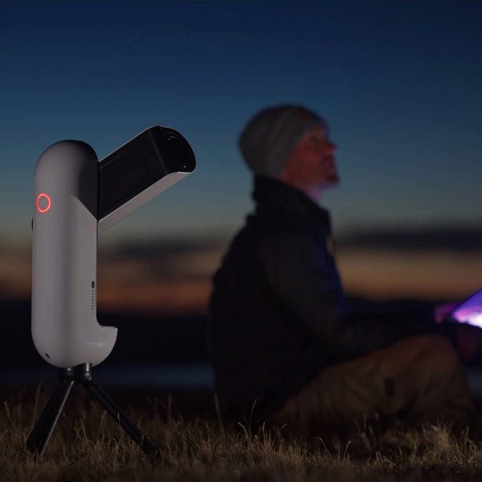 A Man Using the Vaonis Vespera Pro Smart Telescope for Astrophotography