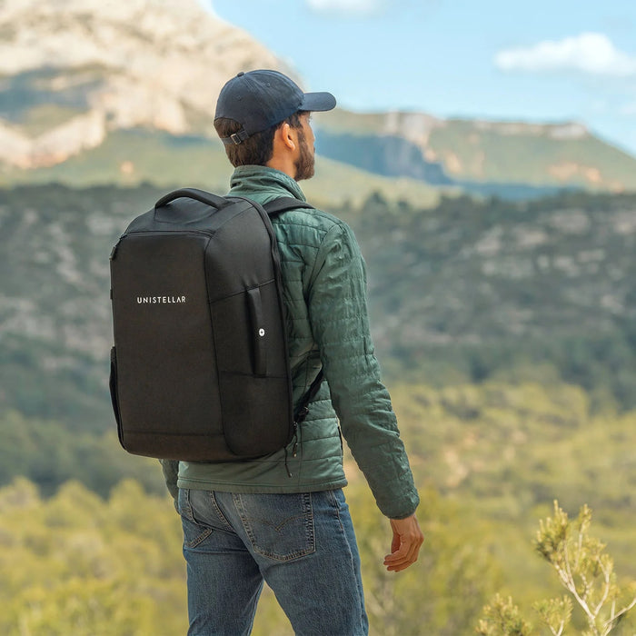 A Man Wearing the Unistellar Backpack for Odyssey Pro and Odyssey Outdoors