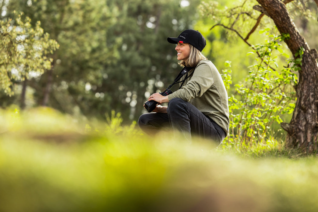 A Woman Holding the Kite Optics 20x42mm ED APC Stabilized Binoculars - Lifestyle Photo Outdoors