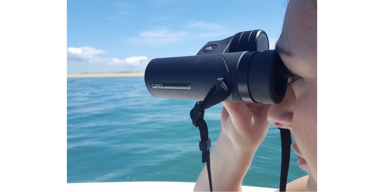 A Woman Using German Precision Optics Passion ED 8×42mm Binoculars Outdoors