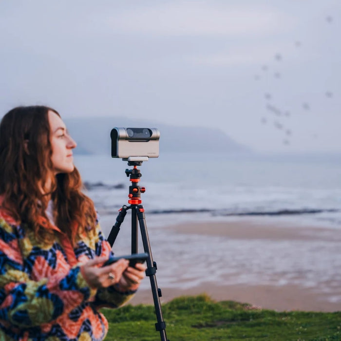 A Woman Using the DWARF 3 Smart Telescope at the Beach