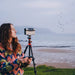 A Woman Using the DWARF 3 Smart Telescope at the Beach