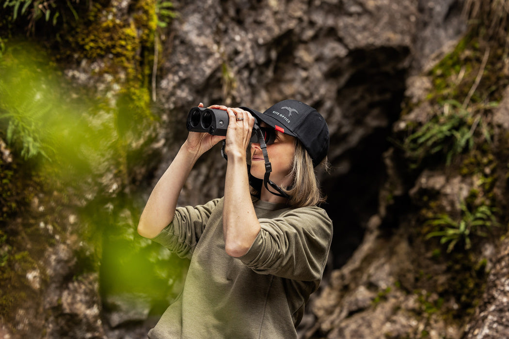A Woman Using the Kite Optics 12x42mm ED APC Stabilized Binoculars - Lifestyle Photo Outdoors