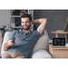 Explore Scientific CrystalVision Advanced Weather Station with LED Touch Keys Beside a Man Indoors