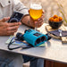 Kite Optics 10x30mm APC Stabilized II Binoculars - Petrol Blue Silicon Jacket On the Table - Lifestyle Photo Outdoor