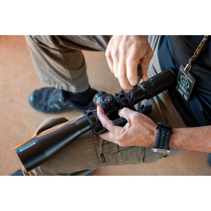 Sightron S6 10-60x56mm ED MOA-BD Bench Rest Riflescope - Shooter Adjusting a Sightron Riflescope Mounted on a Bench Rest Rifle
