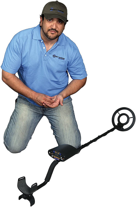 A Man Beside the Bounty Hunter Quick Draw II Metal Detector Bundle with Pin Pointer and Carry Bag